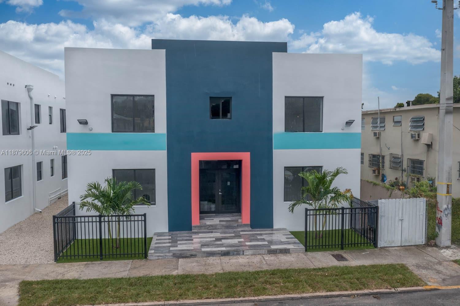 858 Northwest 3rd Street, Unit 112 Miami, FL 33128 - Photo 13 of 15 a view of building with yard