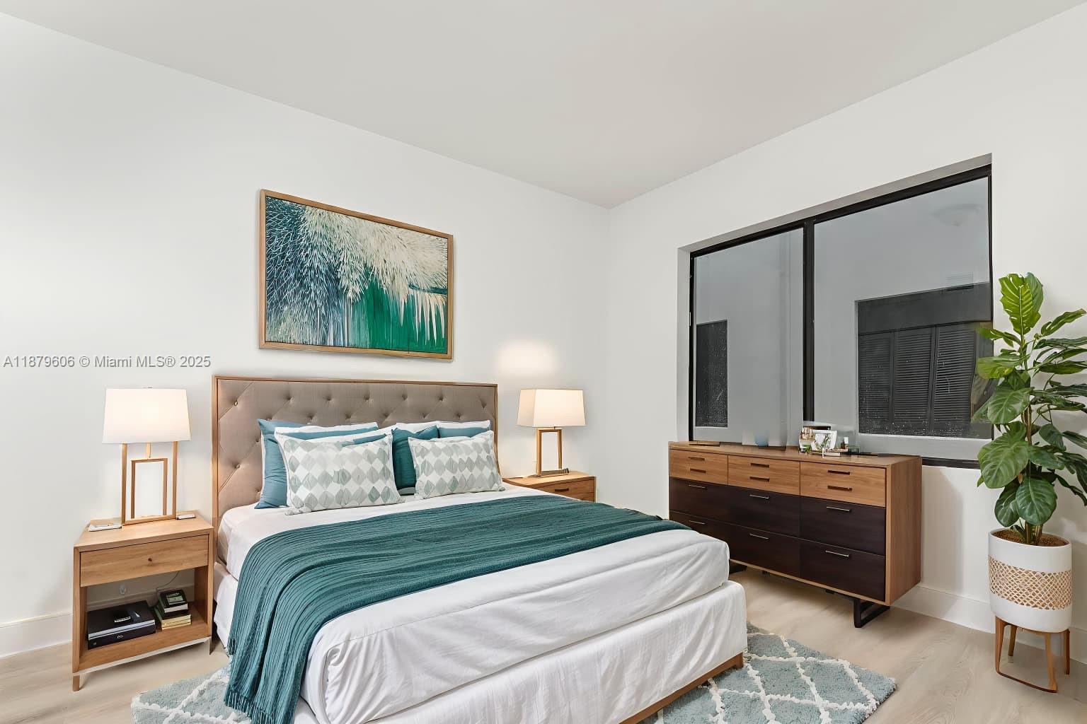 858 Northwest 3rd Street, Unit 112 Miami, FL 33128 - Photo 2 of 15 a bedroom with a bed a potted plant and a dresser