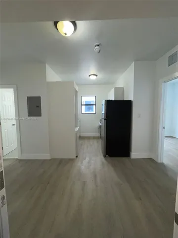 an empty room with windows and closet