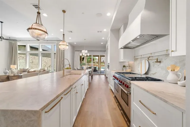 a kitchen with stainless steel appliances granite countertop a stove and a sink