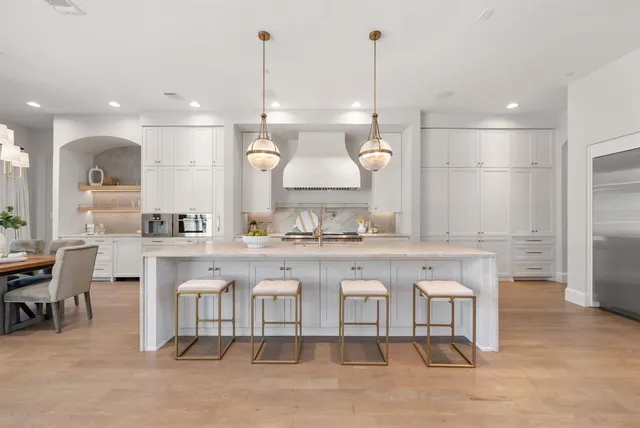 a large kitchen with a table and chairs