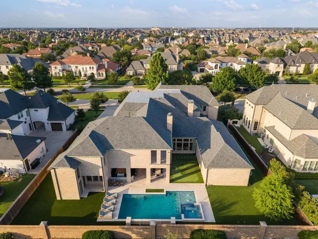 an aerial view of a house with a yard basket ball court and outdoor seating