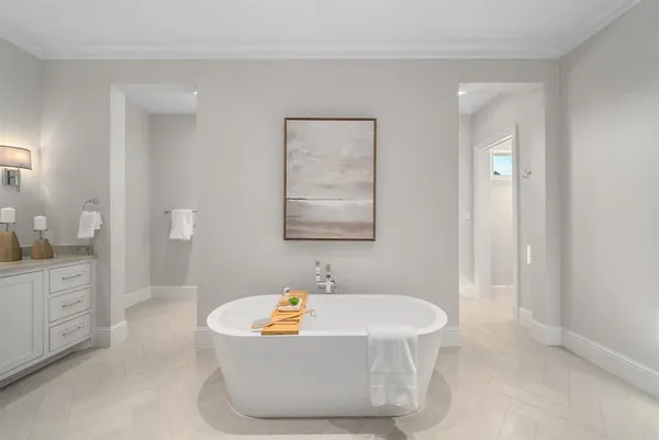 a bath tub sitting next to a bathroom sink