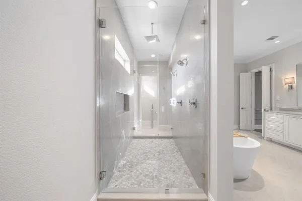 a utility room with wooden floor washer and dryer