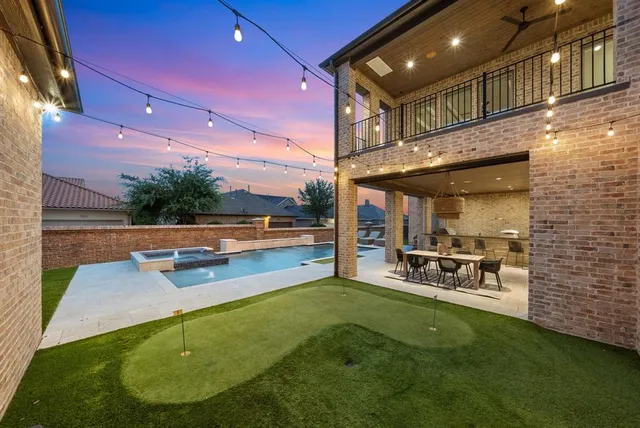 a view of a house with pool and chairs
