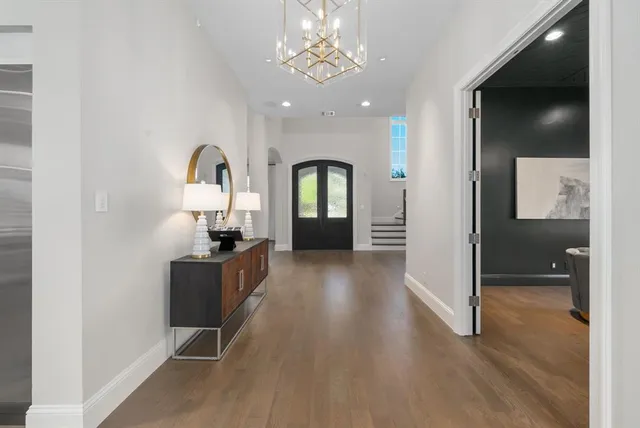 a view of a hallway with wooden floor windows and livingroom