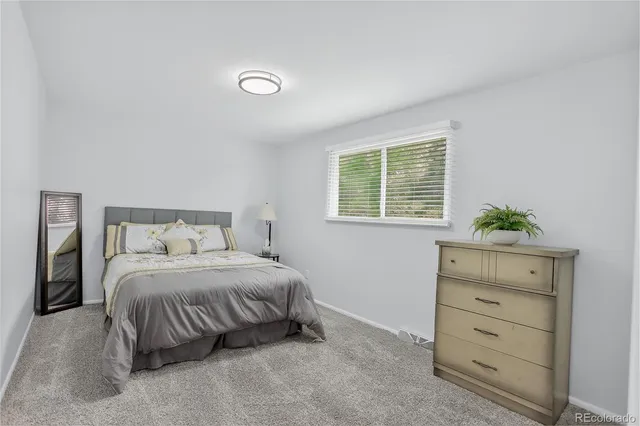 a bedroom with a bed and hallway