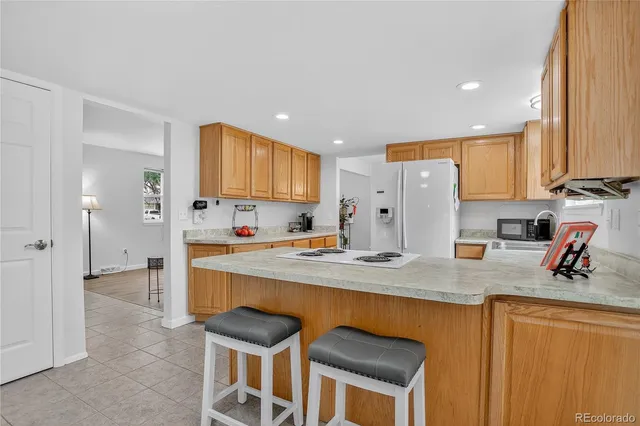 a living room with furniture a fireplace and a floor to ceiling window