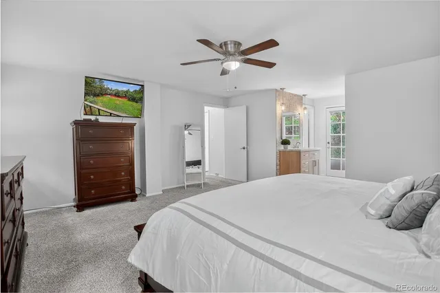 a bedroom with a bed and a ceiling fan