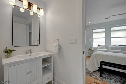 a en suite bathroom with a double vanity sink and a mirror