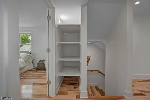 a bathroom with a toilet a sink a large mirror and window