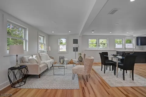 a living room with furniture wooden floor and a window