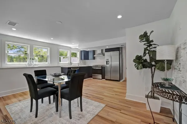 a view of a dining room with furniture and a window