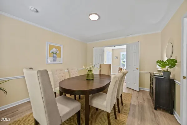 a view of a dining room with furniture and wooden floor