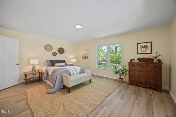 a bedroom with a bed and a window