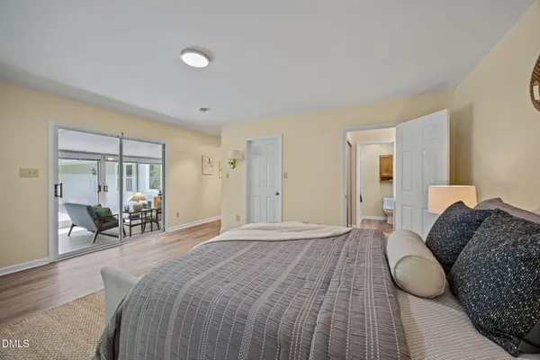 a bedroom with a large bed and a large window