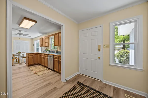 a view of kitchen with sink and refrigerator