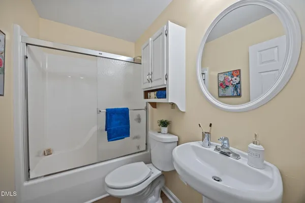 a bathroom with a toilet a sink and a mirror