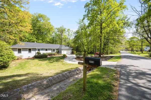 a view of a house with swimming pool and sitting area