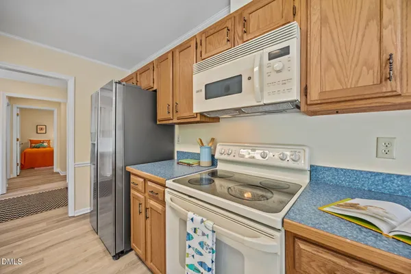 a kitchen with stainless steel appliances granite countertop a refrigerator and a stove
