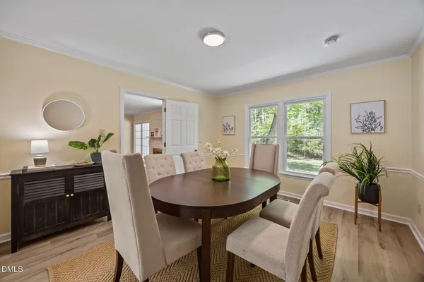 a view of a dining room with furniture window and wooden floor