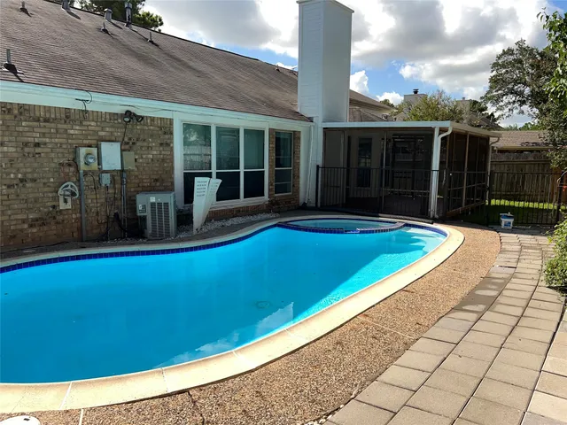 a view of a house with a backyard