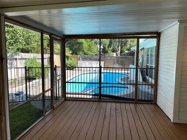 a view of a porch with wooden floor and outdoor space