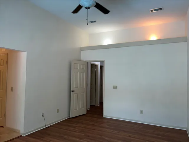 an empty room with wooden floor