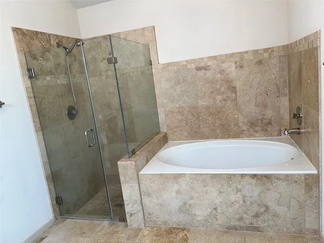 a bathroom with a shower and a tub