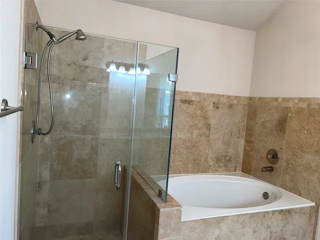 a bathroom with a bathtub and shower