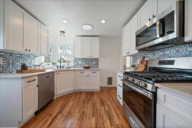 a kitchen with stainless steel appliances a stove microwave and cabinets