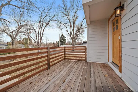 a view of backyard with deck and wooden floor
