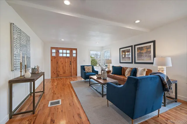 a living room with furniture and wooden floor