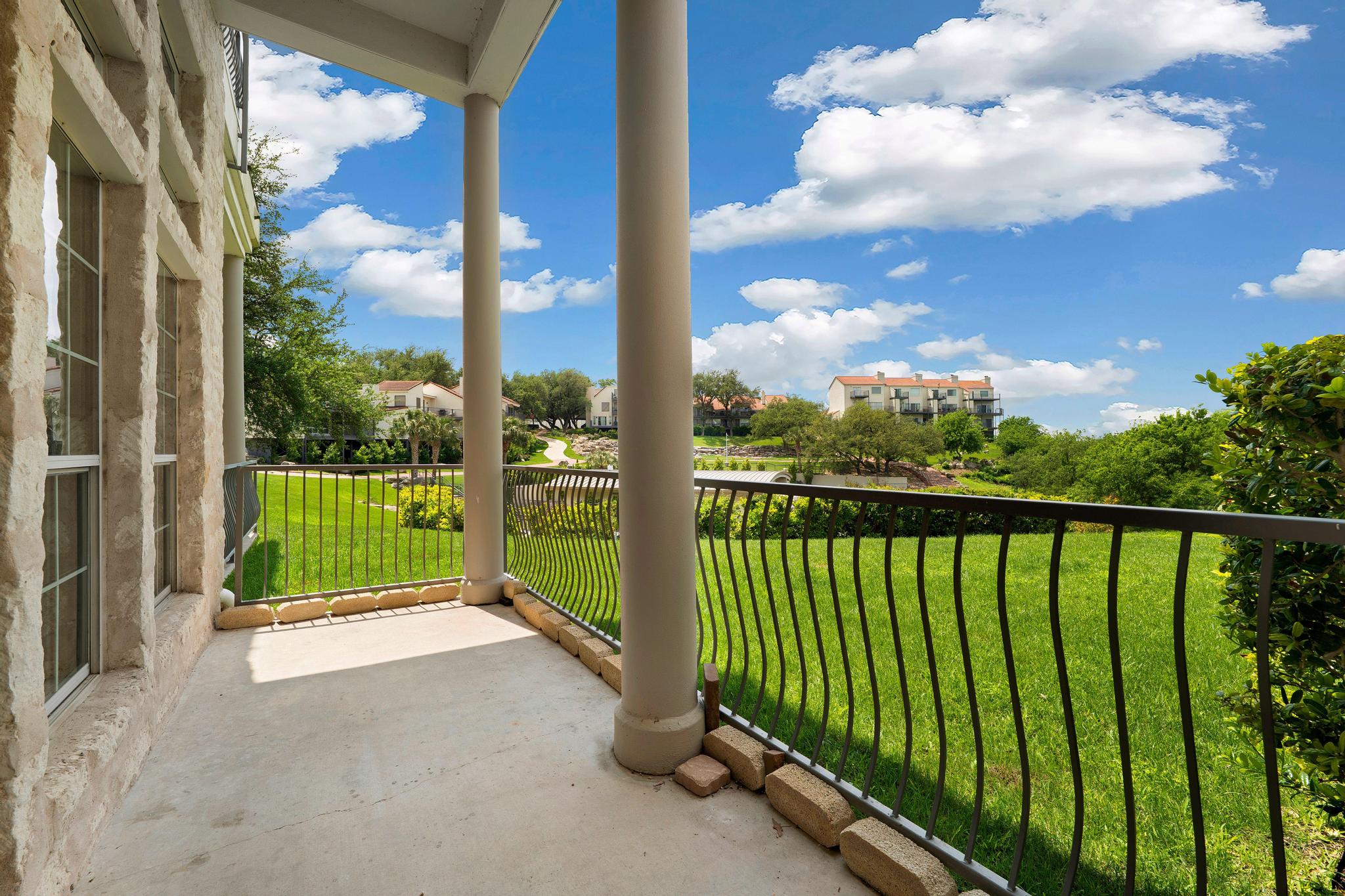 2918 Ranch Road 620, Unit J162 Austin, TX 78734 - Photo 6 of 26 Spacious outdoor balcony/patio, round structural columns, and a wrought iron railing