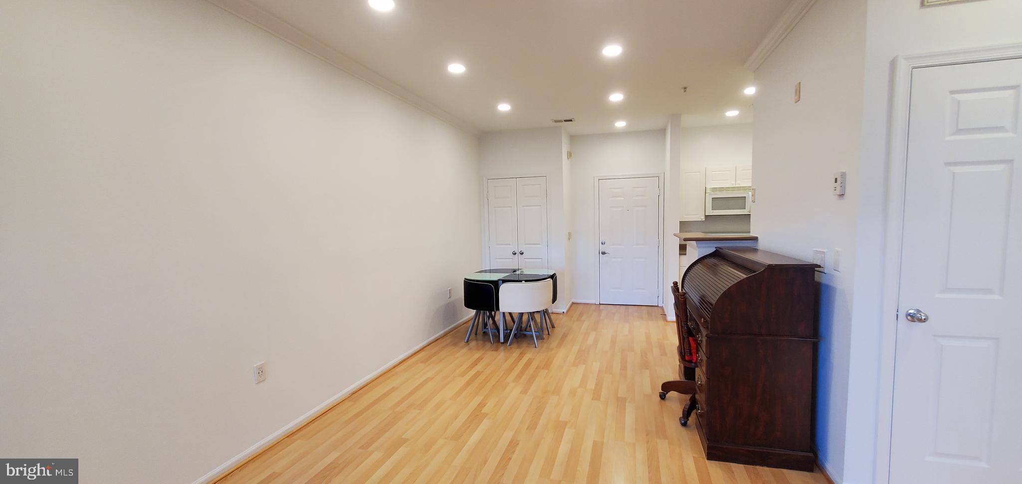 11800 Old Georgetown Road, Unit 1103 Rockville, MD 20852 - Photo 15 of 29 a view of a hallway with wooden floor and furniture