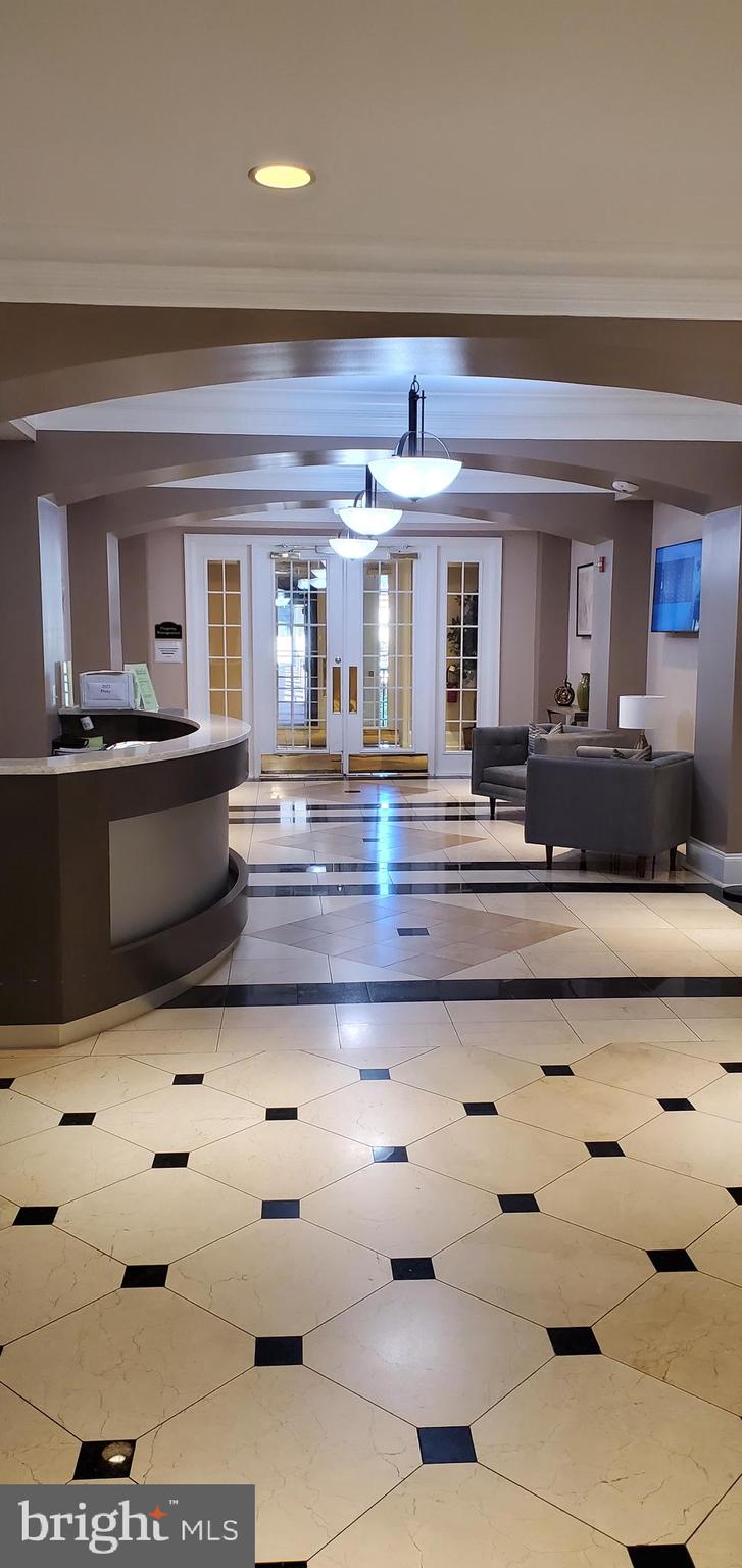 11800 Old Georgetown Road, Unit 1103 Rockville, MD 20852 - Photo 2 of 29 a view of living room with granite countertop furniture and fireplace