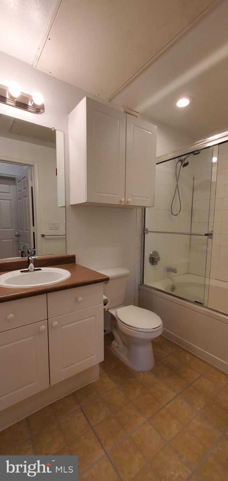 11800 Old Georgetown Road, Unit 1103 Rockville, MD 20852 - Photo 26 of 29 a bathroom with a sink a toilet and shower