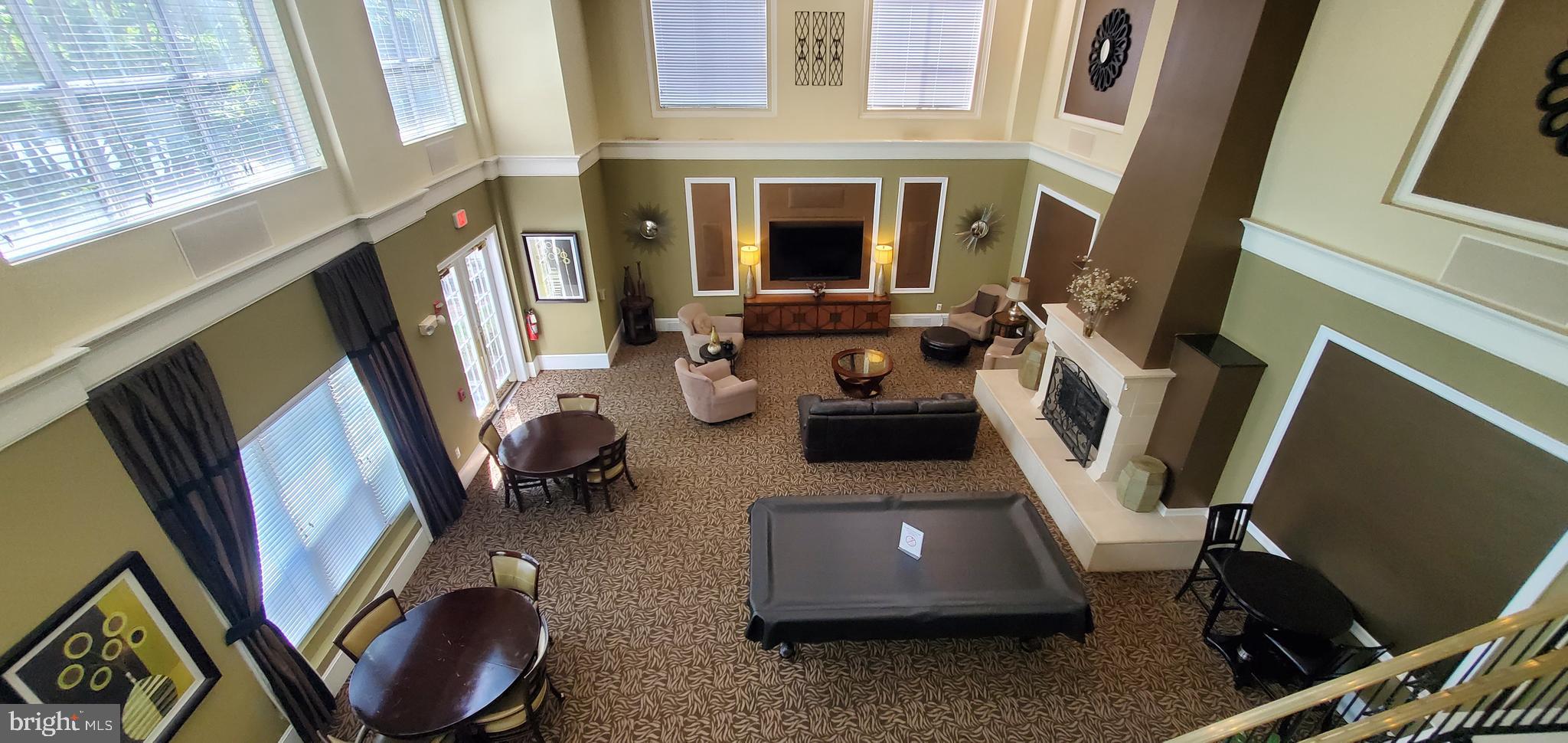 11800 Old Georgetown Road, Unit 1103 Rockville, MD 20852 - Photo 6 of 29 a room with furniture a fireplace and flat screen tv