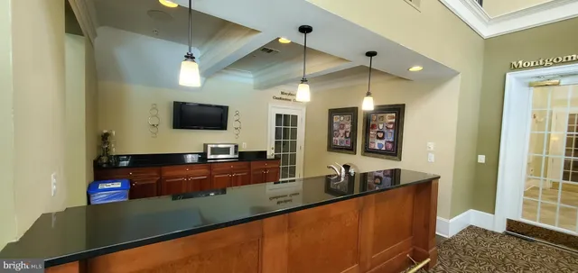 a view of a swimming pool with a patio and a yard