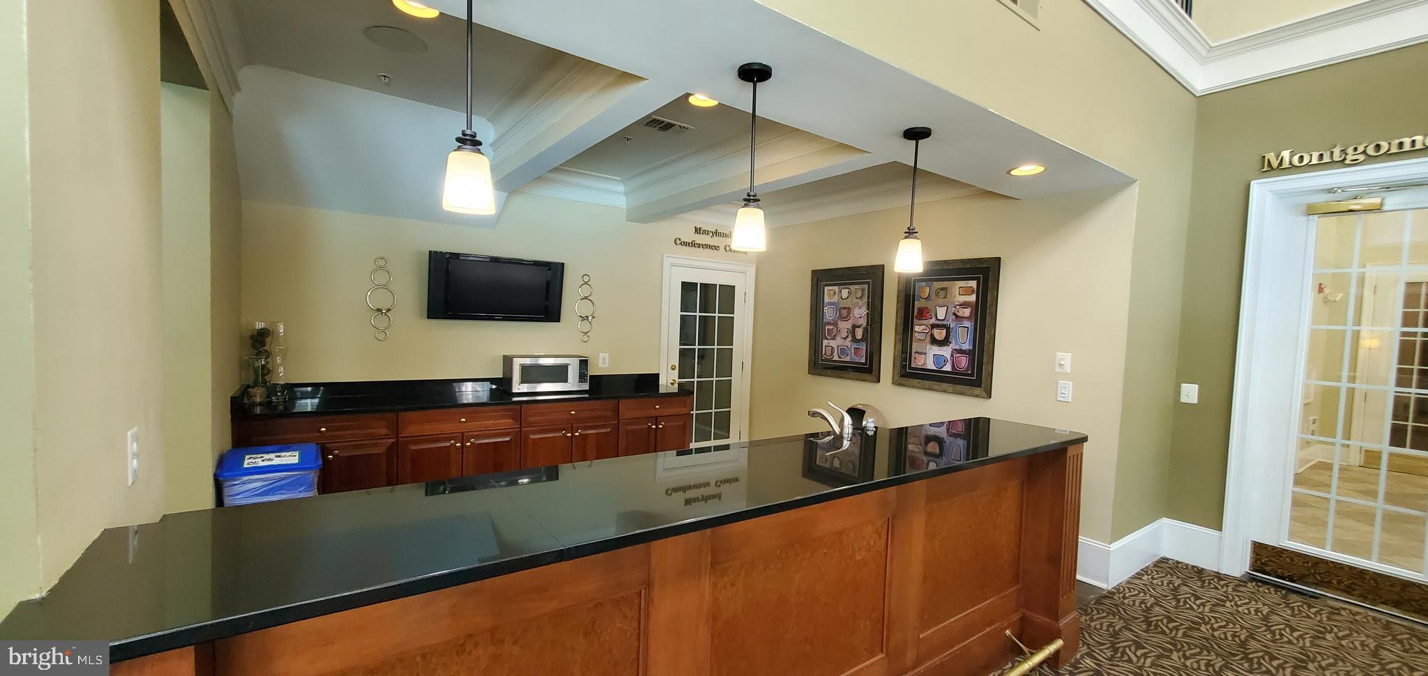 11800 Old Georgetown Road, Unit 1103 Rockville, MD 20852 - Photo 7 of 29 a large kitchen with kitchen island a sink stainless steel appliances and a counter top space