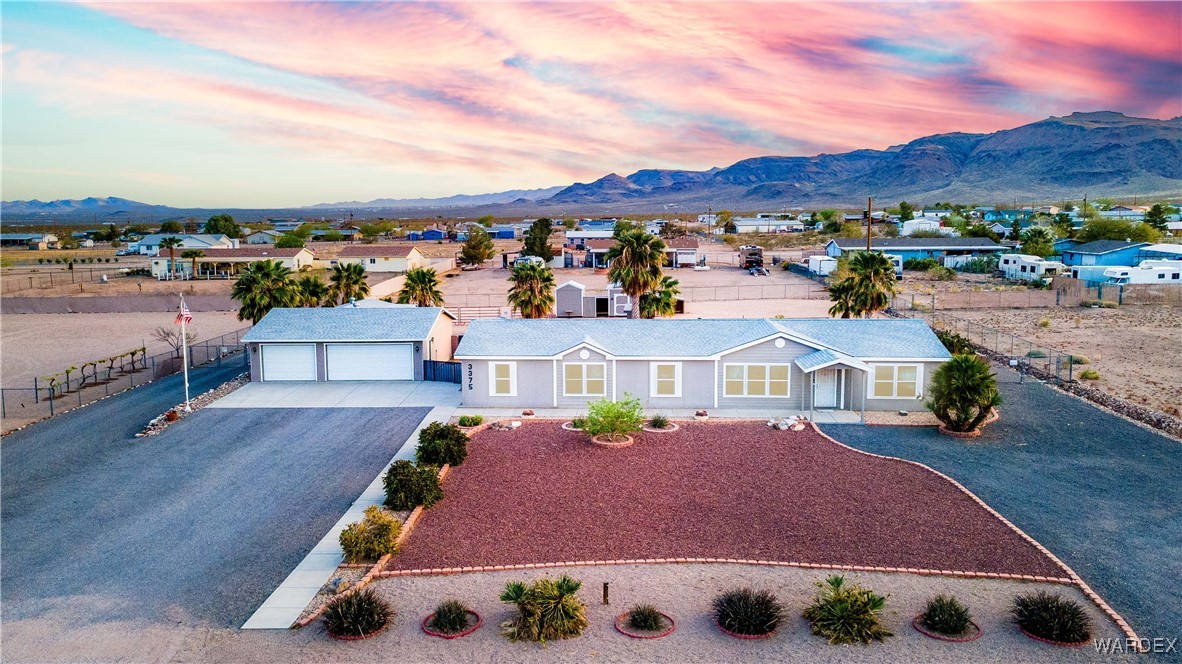 3375 West Rancho Road Golden Valley, AZ 86413 - Photo 1 of 33 a view of multiple houses with a city street