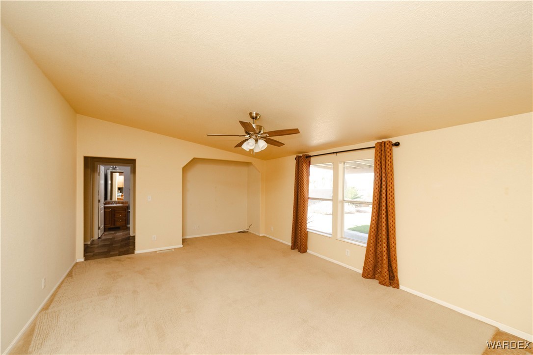 3375 West Rancho Road Golden Valley, AZ 86413 - Photo 12 of 33 a view of a big room with windows and chandelier fan