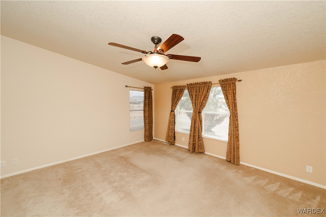 3375 West Rancho Road Golden Valley, AZ 86413 - Photo 16 of 33 a view of an empty room and a ceiling fan