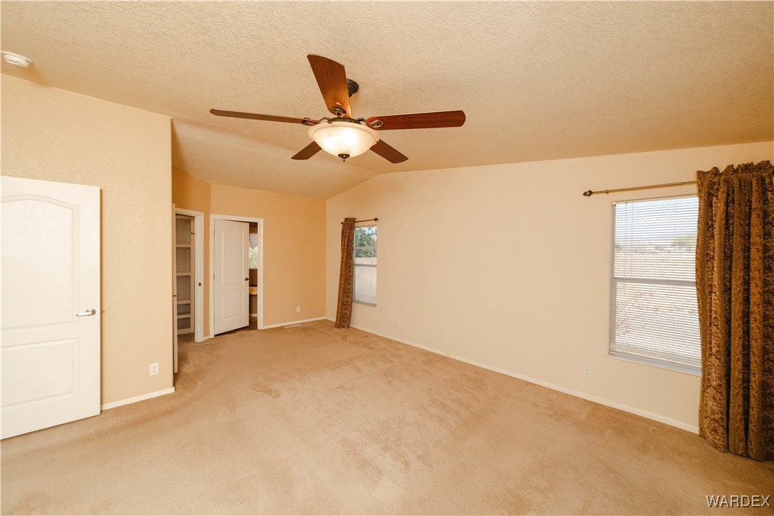 3375 West Rancho Road Golden Valley, AZ 86413 - Photo 17 of 33 a view of a big room with wooden floor and windows in a room