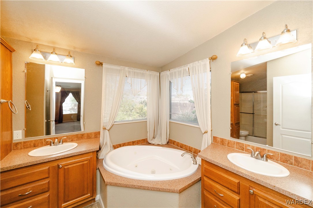 3375 West Rancho Road Golden Valley, AZ 86413 - Photo 21 of 33 a bathroom with a granite countertop sink and a mirror