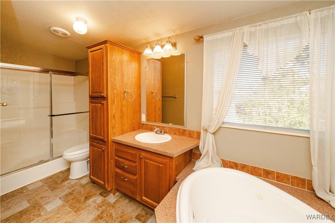3375 West Rancho Road Golden Valley, AZ 86413 - Photo 22 of 33 a bathroom with a sink toilet and shower