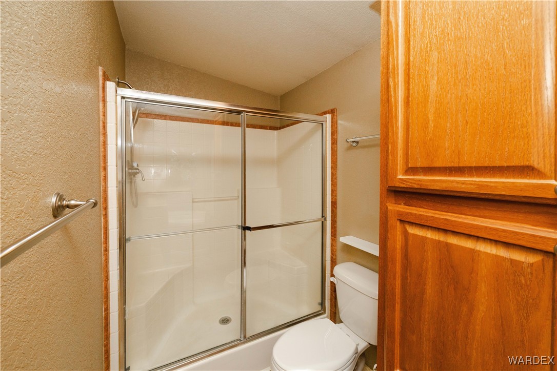 3375 West Rancho Road Golden Valley, AZ 86413 - Photo 23 of 33 a bathroom with a shower and a toilet