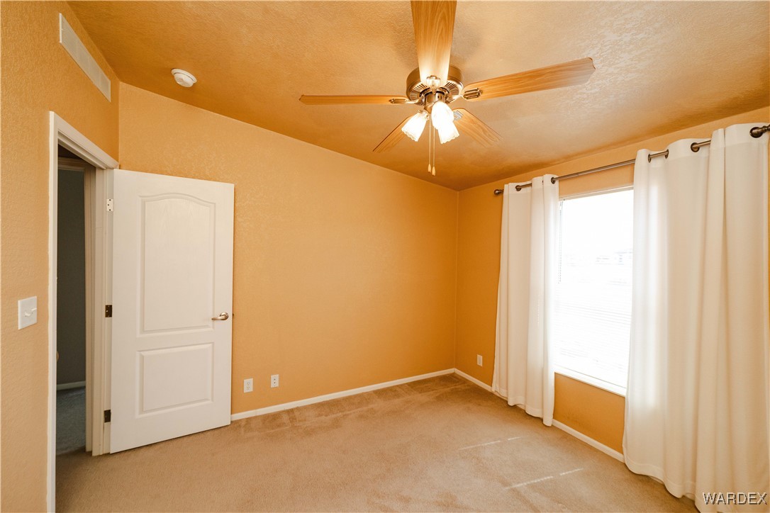 3375 West Rancho Road Golden Valley, AZ 86413 - Photo 27 of 33 a view of an empty room with a window