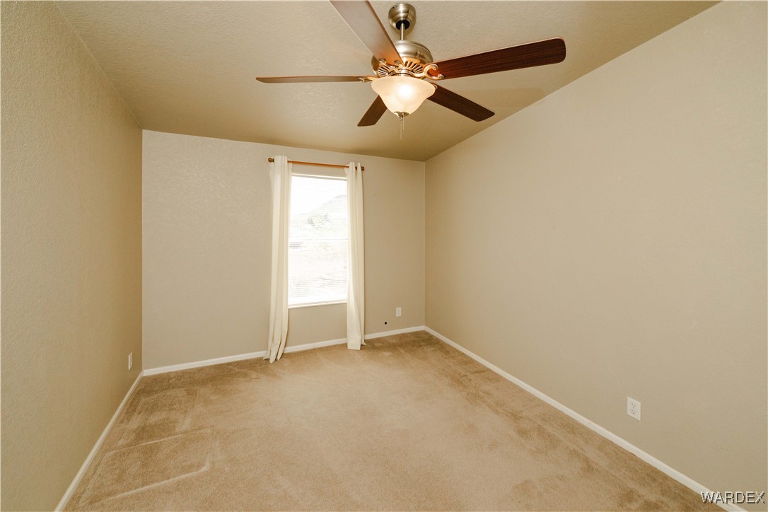 3375 West Rancho Road Golden Valley, AZ 86413 - Photo 30 of 33 an empty room with windows and fan