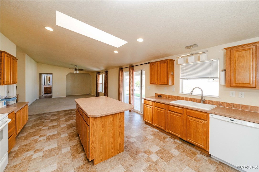 3375 West Rancho Road Golden Valley, AZ 86413 - Photo 7 of 33 a large kitchen with kitchen island a sink counter space and stainless steel appliances